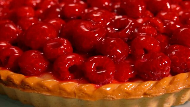 Close-up panorama of a delicious Fresh raspberry jelly-covered pie laying on the plate