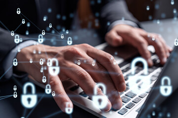 A programmer is typing a code on computer to protect a cyber security from hacker attacks and save clients confidential data. Padlock Hologram icons over the typing hands. Formal wear.