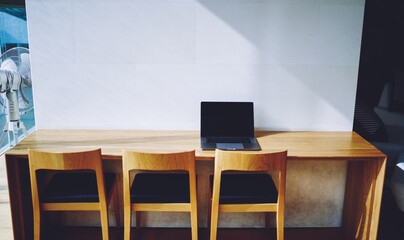 Comfortable workplace with table and laptop