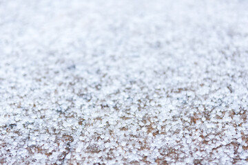 Pieces of the  ice of a hail on the ground outdoors in springtime, unpredictable weather of the season, close up view, narrow DOF  