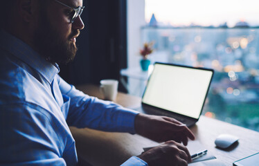 Crop businessman with laptop in office