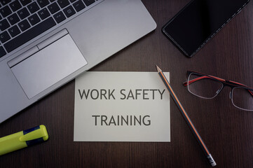 Work place safety training card. Top view of office table desktop background with laptop, phone,...