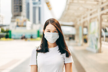 Adult business asian woman wear face mask for protect virus corona or covid19 at outdoor on day. - Powered by Adobe