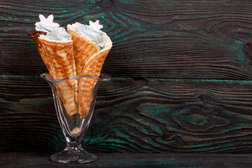 Wafer cones filled with marshmallows. With white and dark chocolate. Decorated with pastille snowflakes.