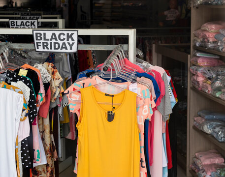 Roupas &agrave; venda em cabides e mostru&aacute;rio promo&ccedil;&atilde;o de black friday