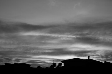 Black and white cloudy sunset at the city