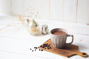 cup of hot chocolate with white wooden background