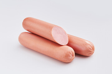 Sausages on a white background. Pieces of sliced sausages isolated