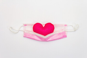 Red heart with medical protection mask isolated on white background