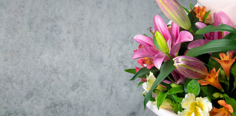 Lily flowers on gray concrete background with copy space. Banner.