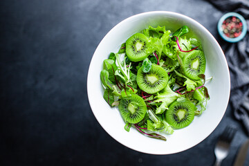 kiwi salad mix lettuce leaves ready to eat on the table healthy meal snack outdoor top view copy...