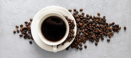 Coffee in a white cup on a gray concrete background.