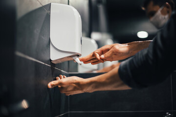top view. a man carefully washes his hands in the bathroom