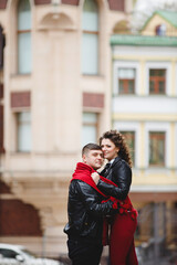 rock style couple in the old City. Happy lovers on the walk outside. Funny couple pair weared in black leather jackets. Romantic walk for young happy family. 