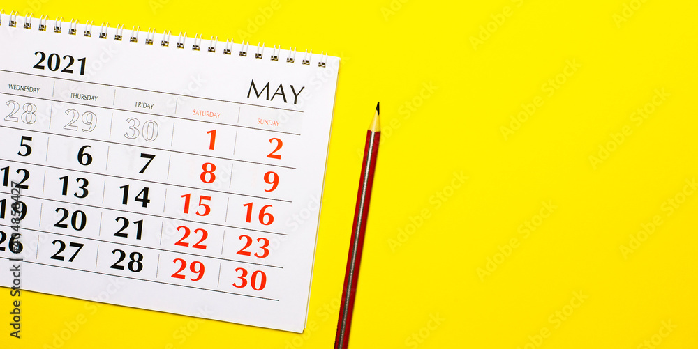 Poster on a yellow background calendar 2021 and a red pencil. top view with copy space