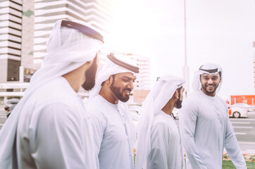 Obraz na płótnie Canvas Group of businessmen talking on the street in Dubai