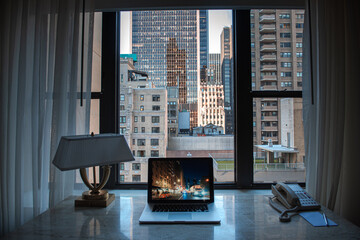 Working office laptop desk with an amazing view to great tall sky scrapers