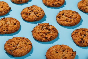 Oatmeal cookies with chocolate chip pattern and patterns on a light blue background.