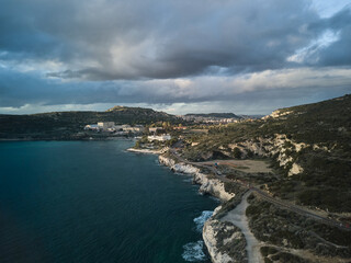 Fototapeta na wymiar Seascape Aerial Shot (calamosca) with calm sea at sunset in Caglairi - Sardinia.