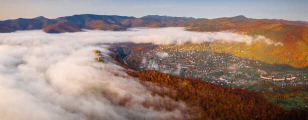 Breathtaking morning landscape in alpine foggy valley.