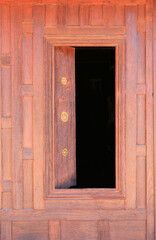 Open window. Thai style wooden windows on brown wood wall background