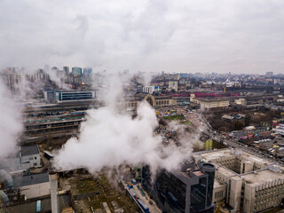 Fototapeta na wymiar Aerial drone view. The building of the Kiev railway station through the white smoke from the chimneys.