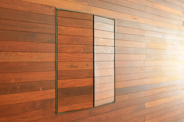 Perspective Brown wood plank wall and windows background with ray of light.