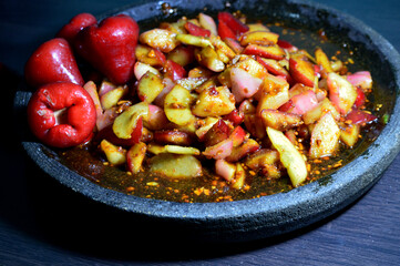Rujak Jambu is a guava fruit that is cut and then mixed with peanut sauce