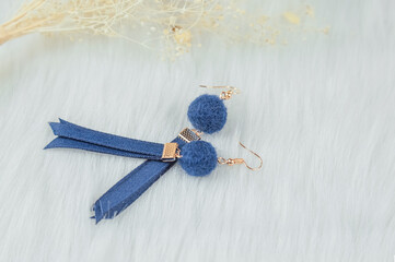 Dry yellow flowers are ornaments. Blue pompom streamer earrings.