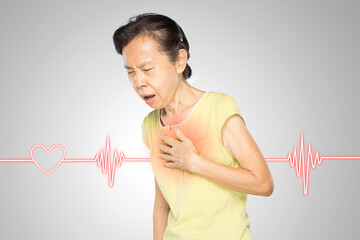 old asian woman puts her hand on her chest feels chest pain has heart disease
