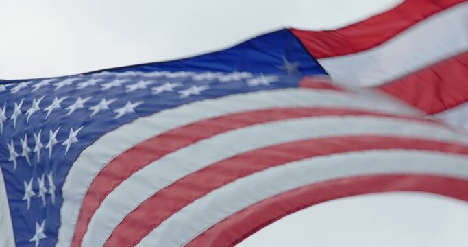 Close Up Details of American Flag Silk on Flagpole with Red, White and Blue Stars and Stripes in 4k Slow Motion