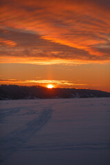 Dawn in the winter on the ice-covered river. Winter morning.