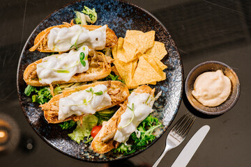 Dish of ciabatta bread with pulled meat and melted goat cheese