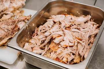 A chef preparing pulled pork meat. American traditional cuisine