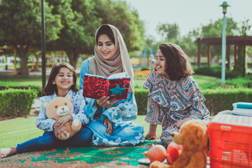 Mom and daughters spending time together at the park, in Dubai