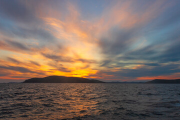 Picturesque sunset on the sea among the clouds on a summer evening. Tobisina Cape, Russian island, Vladivostok.