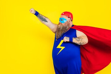 Funny man wearing a superhero costume - obrazy, fototapety, plakaty