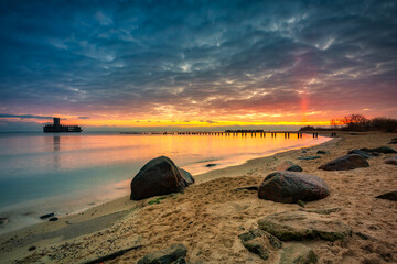 Sunrise over the beach and torpedo platform at Baltic Sea in Babie Doly, Gdynia. Poland