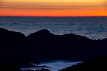 Sunrise with sea of clouds in horizon