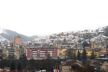 Fototapeta premium houses and buildings of various colors on the snow