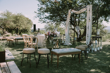 white couches, candles and flowers for ceremony