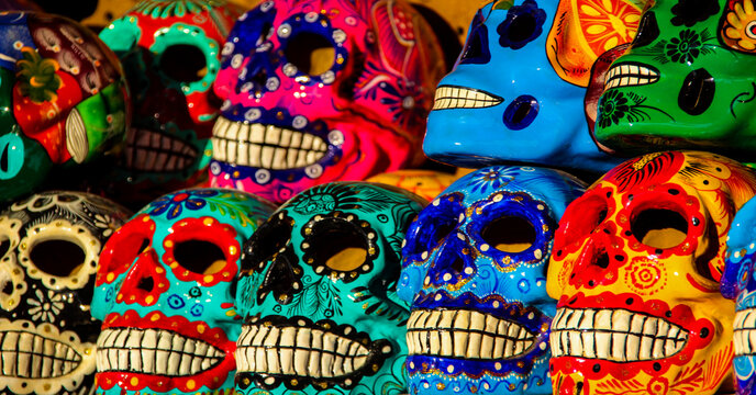 Calacas, wooden skull Day of the Dead masks on market in Cabo San Lucas, Mexico