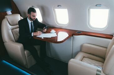 Businessman flying on his private jet.