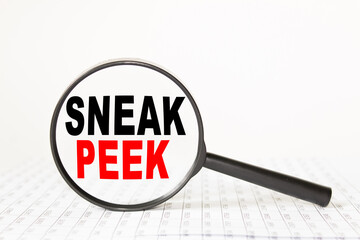 words SNEAK PEEK in a magnifying glass on a white background. business concept