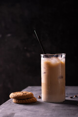 A glass of iced latte and chocolate cookies