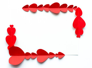 Valentine's Day background. Red paper hearts are lined with a rectangle, not closed, on a white background with place for text. Bright colorful hearts for postcards. - 404883422