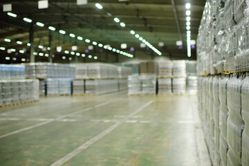 a huge industrial warehouse with plastic food wrap wrapped plastic bottles with carbonated drinks,  water or beer.