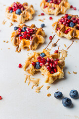 Fresh delicious waffles with nut paste and berries. Blueberry waffles for breakfast