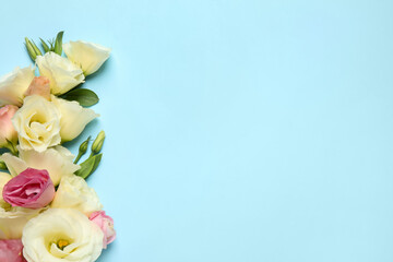 Obraz na płótnie Canvas Beautiful Eustoma flowers on light blue background, flat lay. Space for text