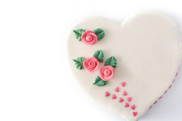 Heart cake for St. Valentine's Day, Mother's Day, or Birthday, decorated with roses and pink sugar hearts isolated on white background